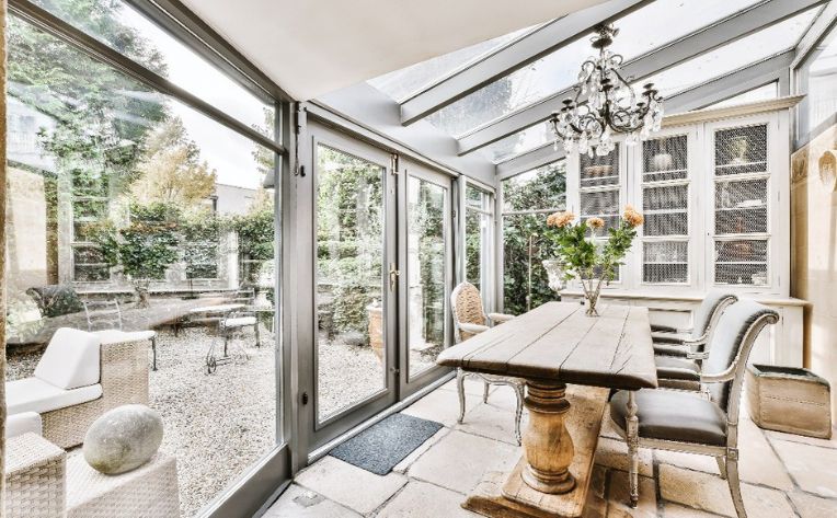 Sunroom interior with a table and three chairs